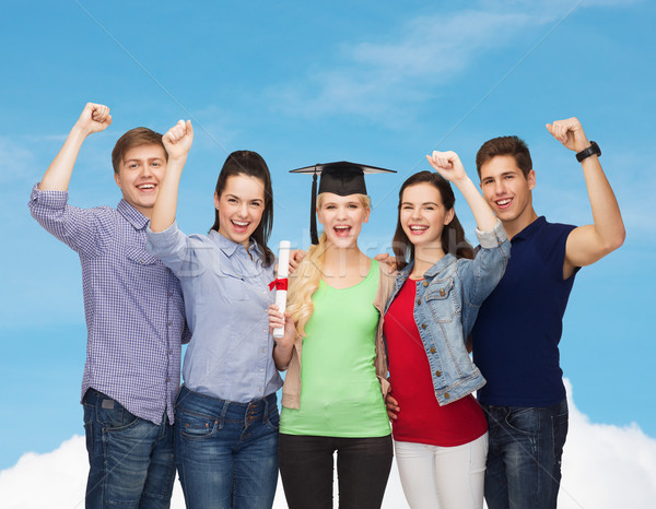 group of standing smiling students with diploma Stock photo © dolgachov