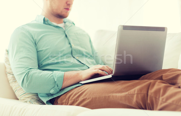 close up of man working with laptop at home Stock photo © dolgachov