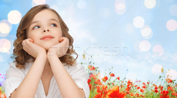 happy girl dreaming over poppy field background Stock photo © dolgachov