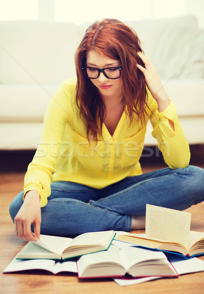 smiling student girl reading books at home Stock photo © dolgachov