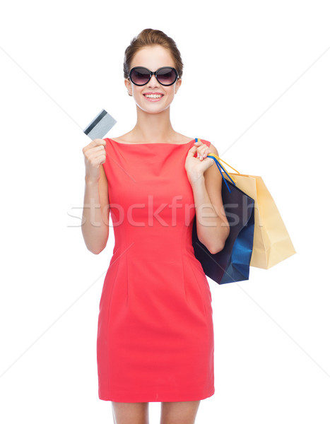 smiling woman with shopping bags and plastic card Stock photo © dolgachov