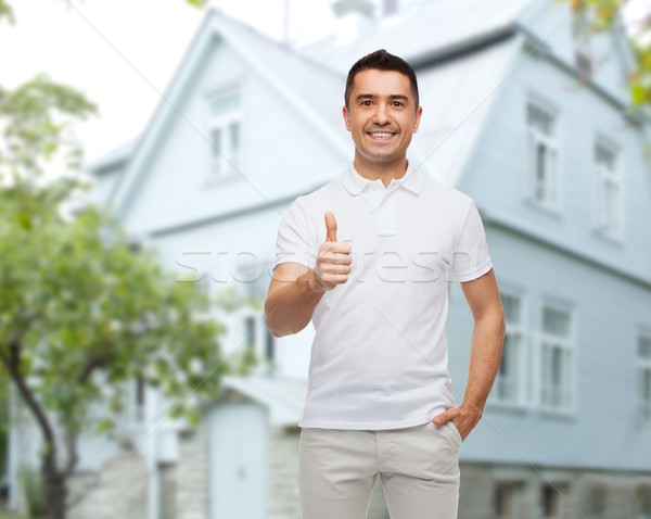 Man tonen huis geluk gebaar Stockfoto © dolgachov