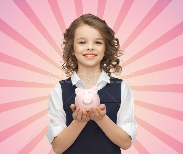 happy girl holding piggy bank on palms Stock photo © dolgachov