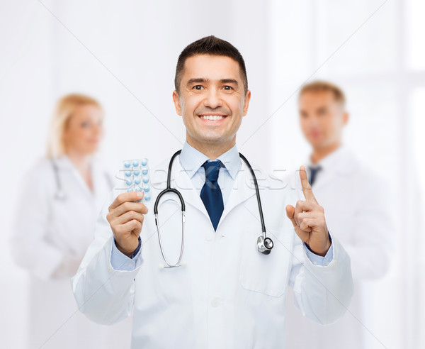 [[stock_photo]]: Souriant · médecin · de · sexe · masculin · blanche · manteau · santé · profession