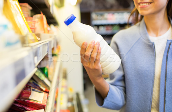 happy woman holding milk bottle in market Stock photo © dolgachov