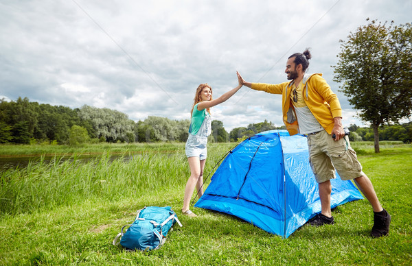 happy couple setting up tent outdoors Stock photo © dolgachov