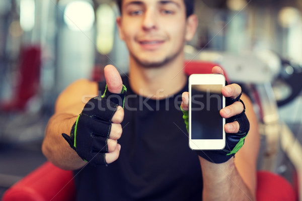 Jeune homme smartphone gymnase sport [[stock_photo]] © dolgachov