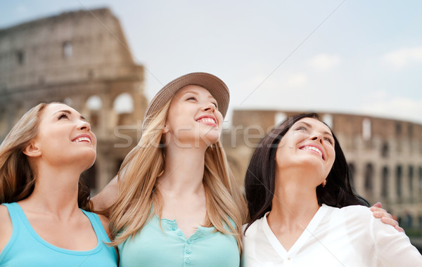 group of happy young women over coliseum Stock photo © dolgachov