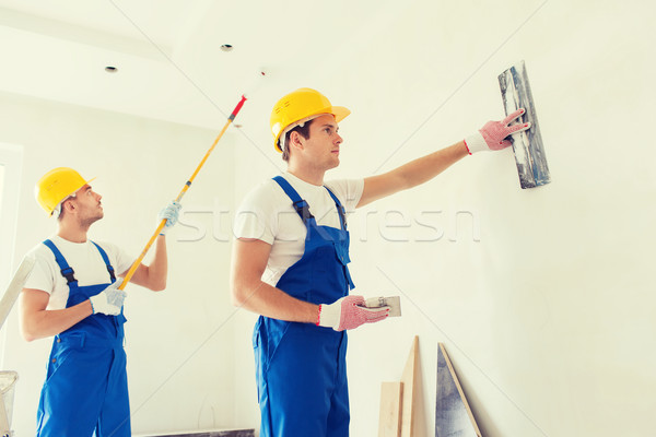 group of builders with tools indoors Stock photo © dolgachov