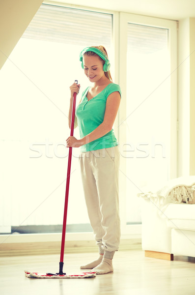 happy woman with mop cleaning floor at home Stock photo © dolgachov