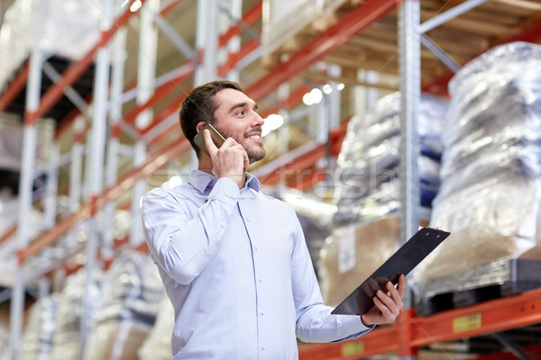 Stock photo: man with clipboard and smartphone at warehouse