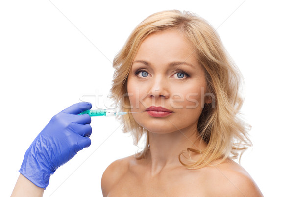 Vrouw gezicht hand spuit schoonheid cosmetische chirurgie handschoen Stockfoto © dolgachov