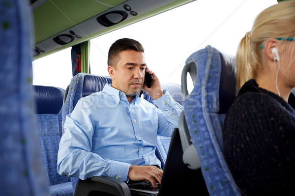 man with smartphone and laptop in travel bus Stock photo © dolgachov