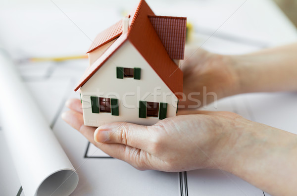 close up of hands with house model above blueprint Stock photo © dolgachov