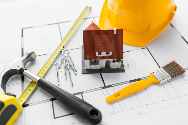 Stock photo: close up of house blueprint with building tools