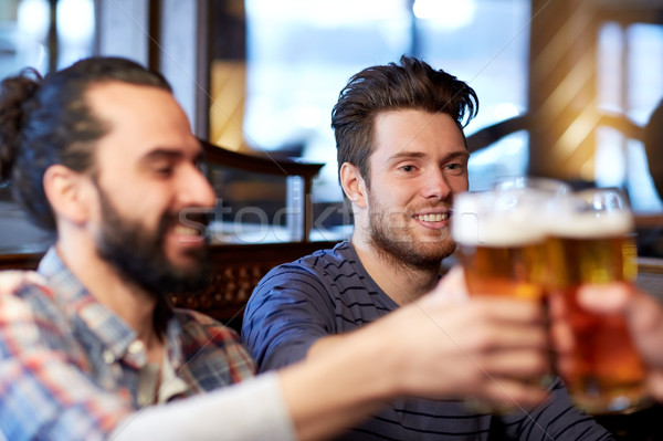 happy male friends drinking beer at bar or pub Stock photo © dolgachov