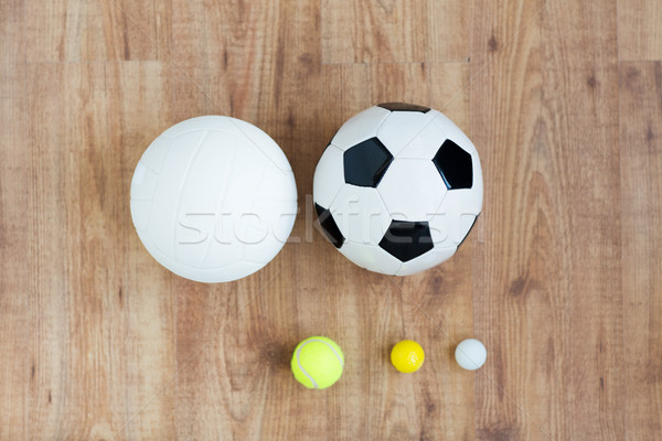 close up of different sports balls set on wood Stock photo © dolgachov