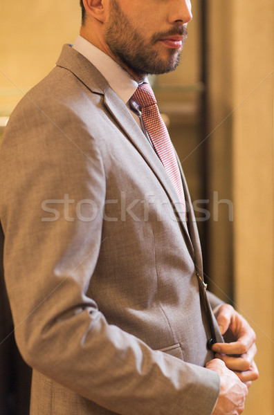 close up of man trying suit at clothing store Stock photo © dolgachov