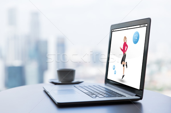 Stock photo: close up of laptop with fitness app and coffee cup