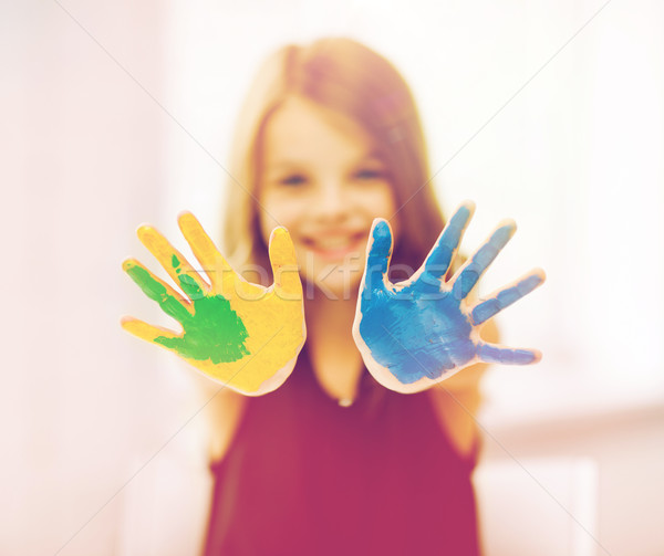 Stock photo: happy girl showing painted hands