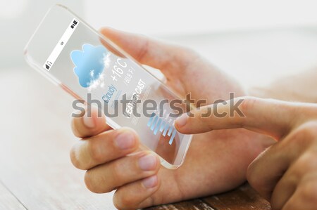 close up of male hand with weather cast smartphone Stock photo © dolgachov