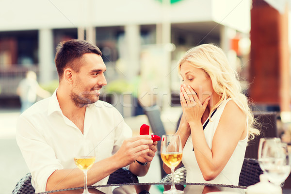 happy couple with engagement ring and wine at cafe Stock photo © dolgachov