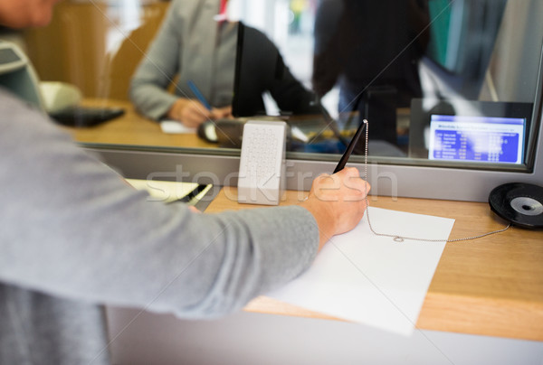customer writing application at bank office Stock photo © dolgachov