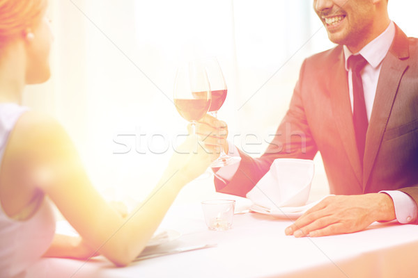 happy couple with glasses of wine at restaurant Stock photo © dolgachov