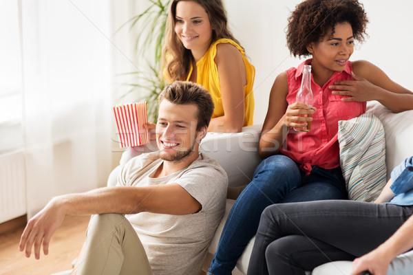 Stock photo: friends with beer talking and watching tv at home