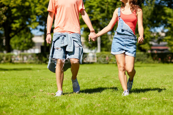 happy teenage couple walking at summer park Stock photo © dolgachov