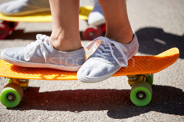 close up of feet riding skateboards on city street Stock photo © dolgachov