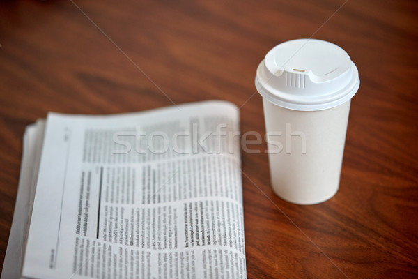 coffee drink in paper cup and newspaper on table Stock photo © dolgachov