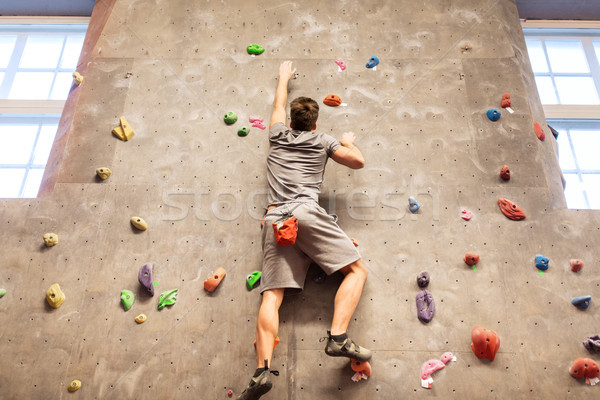 young man exercising at indoor climbing gym Stock photo © dolgachov