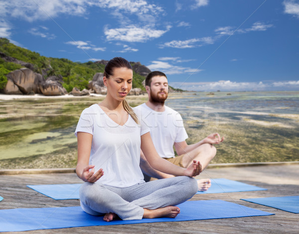 people meditating in yoga lotus pose outdoors Stock photo © dolgachov