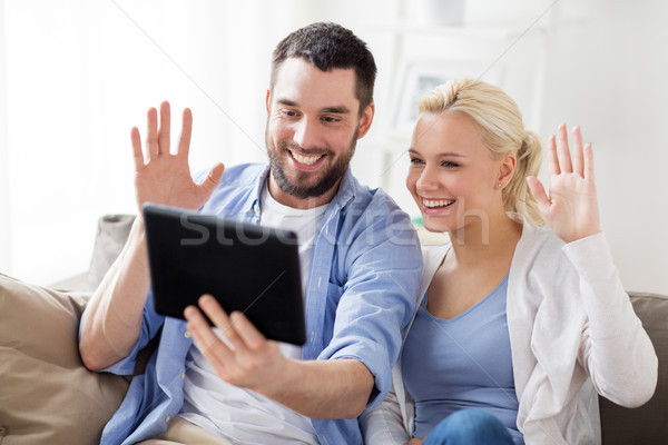 Stock photo: couple with tablet pc having video chat at home