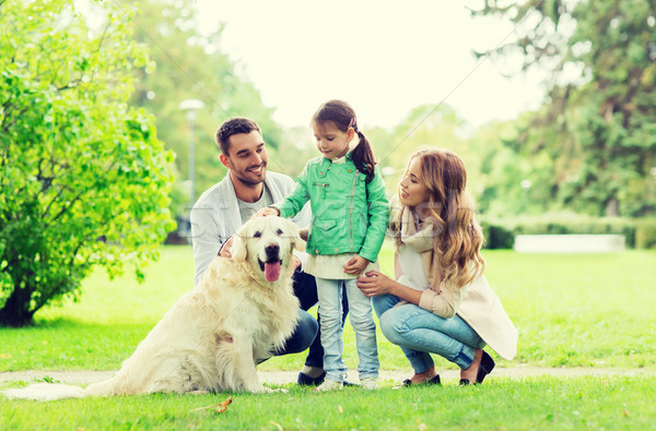 happy family with labrador retriever dog in park Stock photo © dolgachov