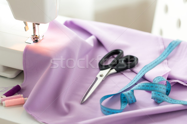 sewing machine, scissors, tape measure and fabric Stock photo © dolgachov