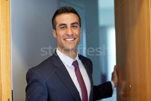 businessman at hotel room or office door Stock photo © dolgachov