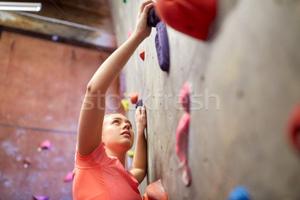 young woman exercising at indoor climbing gym wall Stock photo © dolgachov