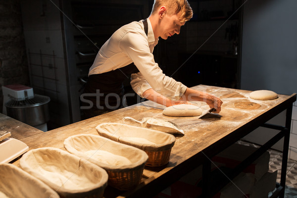 chef or baker making dough at bakery Stock photo © dolgachov