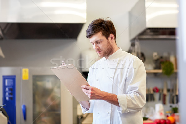 chef with clipboard doing inventory at restaurant Stock photo © dolgachov