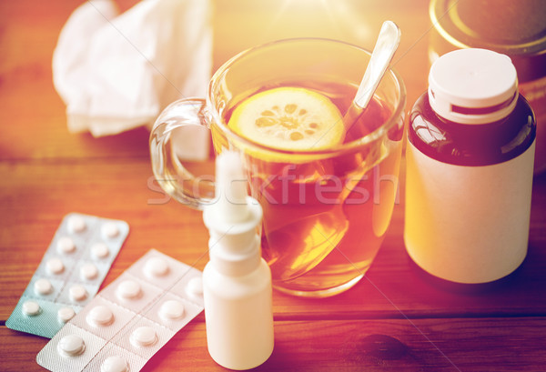 cup of tea, drugs, honey and paper tissue on wood Stock photo © dolgachov