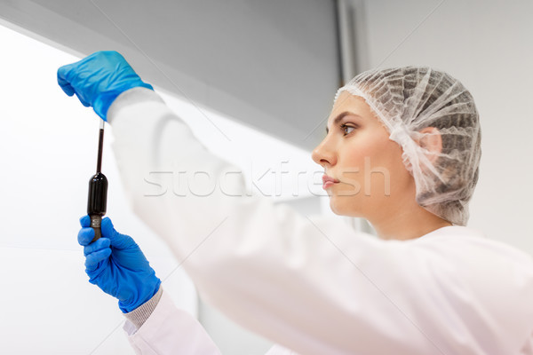 woman with sulphuric acid in dropper at laboratory Stock photo © dolgachov