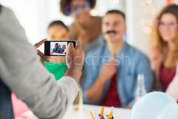 Stock photo: friends or coworkers photographing at office party