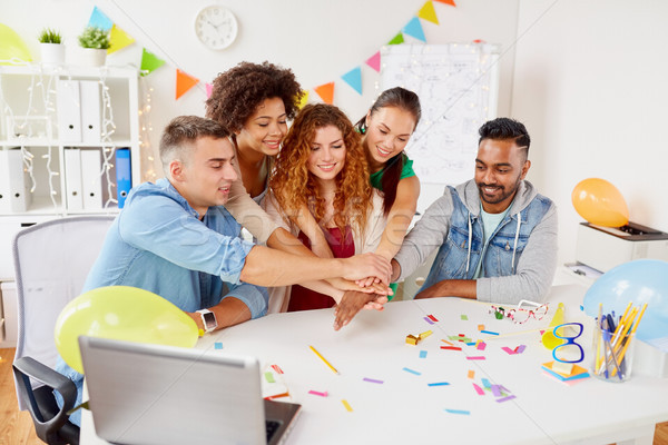 happy business team at office party holding hands Stock photo © dolgachov