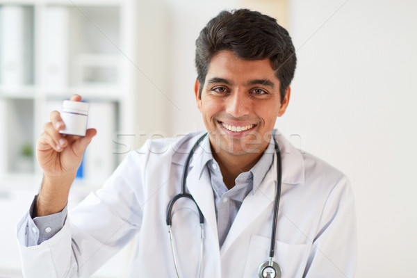 happy doctor with stethoscope and medication Stock photo © dolgachov