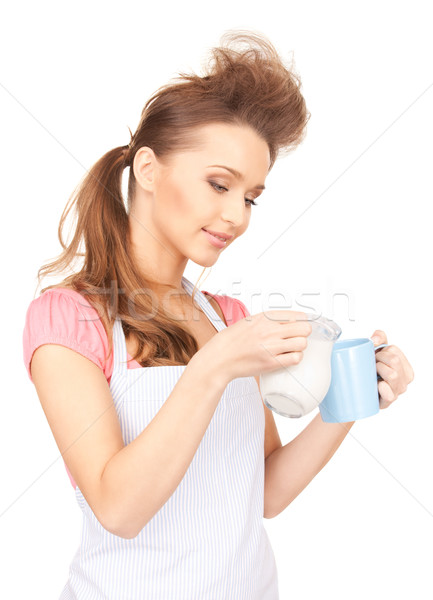 housewife with milk and mug Stock photo © dolgachov