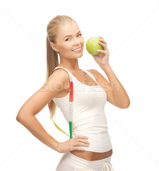 Stock photo: sporty woman with apple and measuring tape