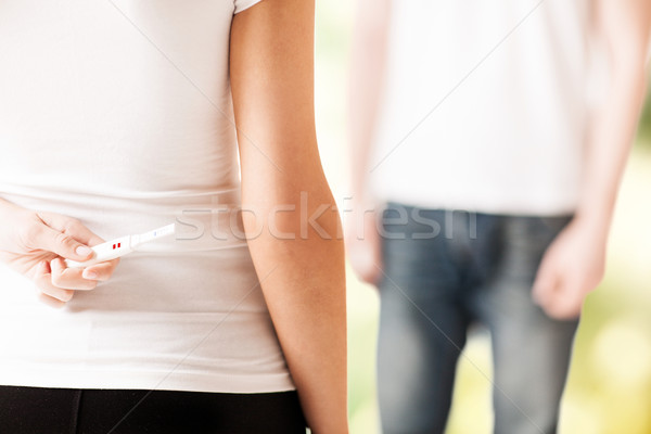 Stock photo: woman hiding pregnancy test