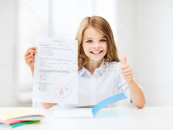 Stock photo: girl with test and grade at school